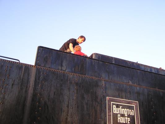 David and Noah on top of a train in Alliance