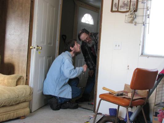 David and Robert fix the door.