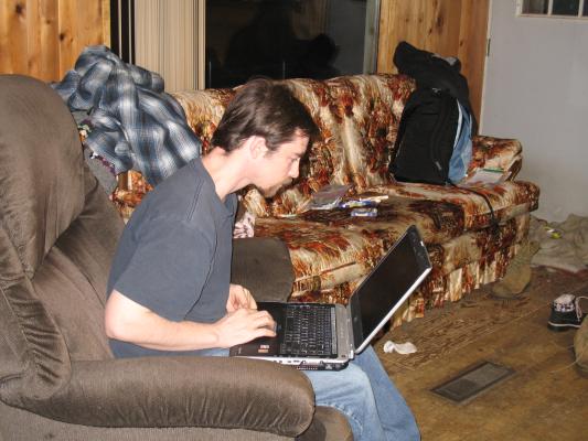 Jim plays with his computer.