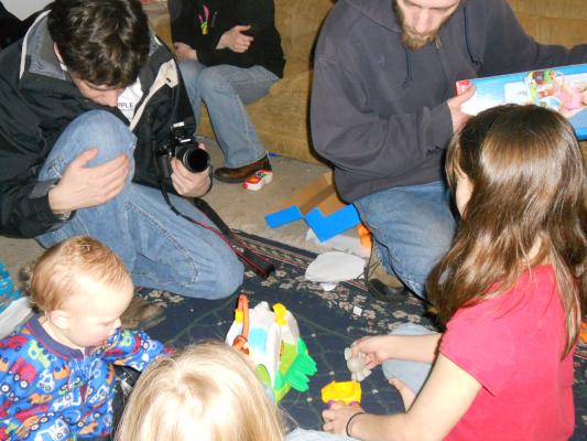 Everyone checks out Joshua's first birthdya gifts.