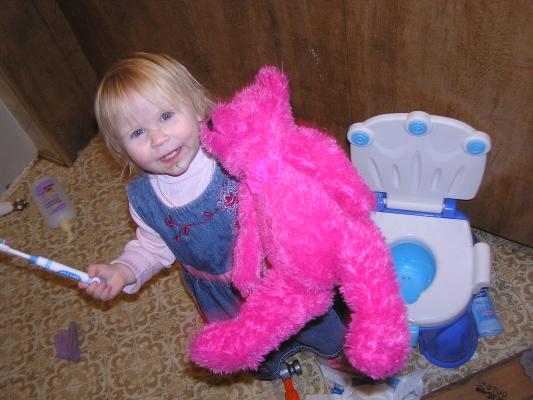 Sarah brushes the bear's teeth