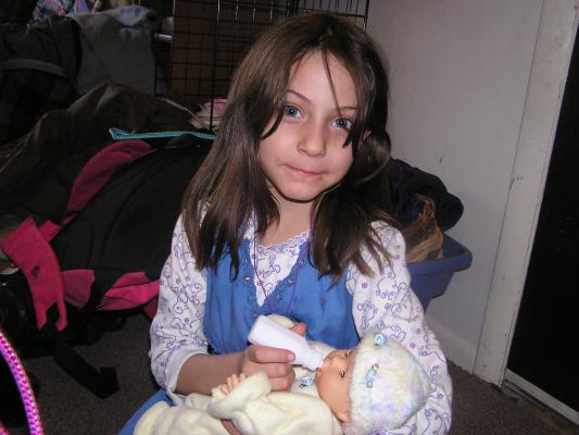 Andrea feeds Sarah's new baby.