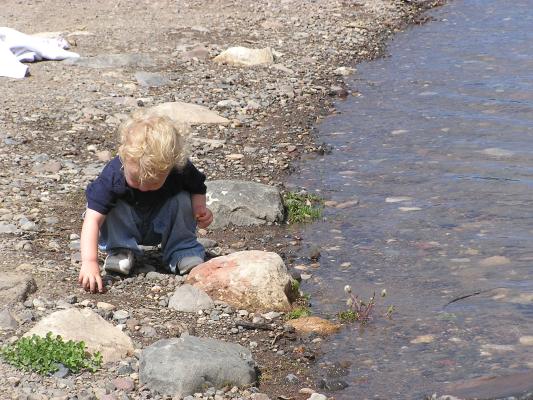 Noah gets some more rocks to throw.