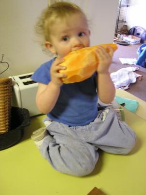 Noah takes a bite out of the big sweet potato.