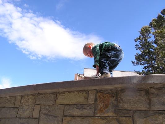Noah climbs the wall.