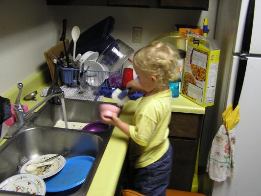 Noah washing dishes.