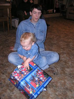 Noah opens a present from great grandma and great grandpa.