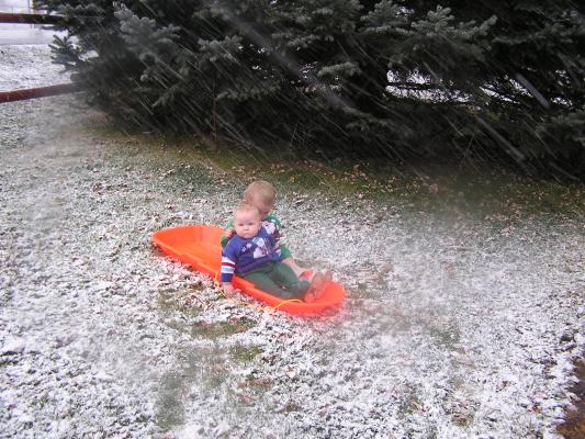 Sarah and Noah get pictures on a sled.