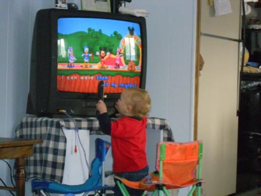 Joshua trying to play the game with a remote. 