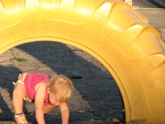 Sarah under the yellow tire