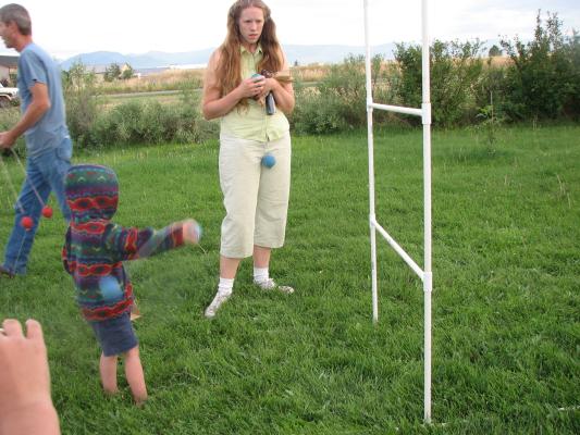 Noah plays Bolo Ball while Katie watches. 