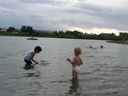 Noah watches Malia play in the water.