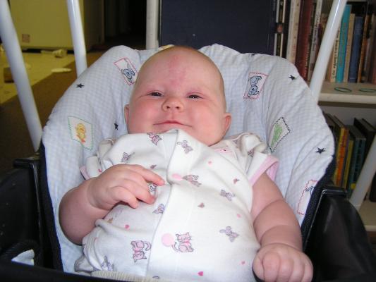 Sarah smiling in her swing.