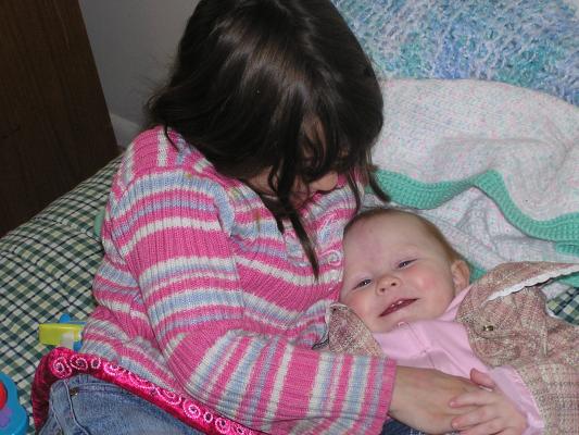 Andrea tickels Sarah so we can see her teeth.