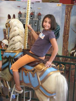 Malia rides horse.