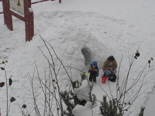 Noah and Katie outside by the snow fort.
