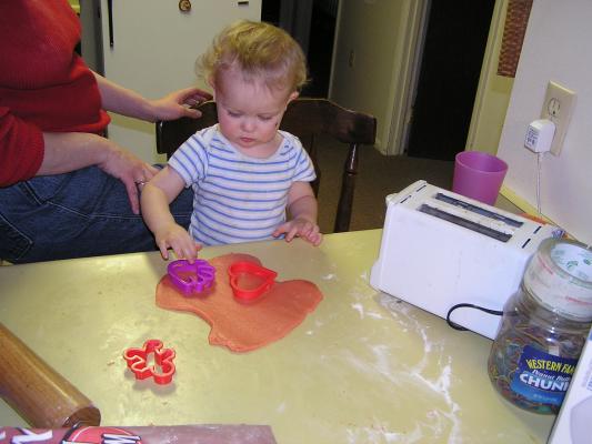Noah cuts out sugar cookies for Valentines Day.