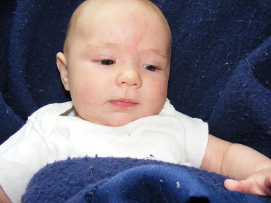 Joshua in a blue blanket.