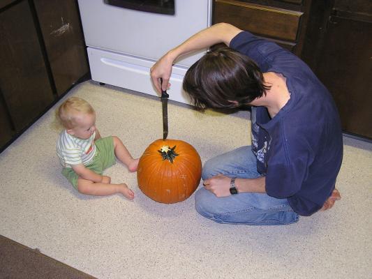 The first step to carving a pumpkin is to cut a hole in the top.