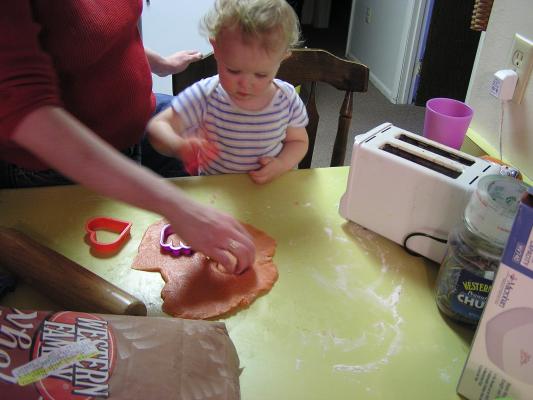 Let's cut out some shapes: hearts, hands, and ginerbread men.