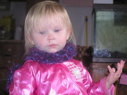 Sarah in a scarf and pink jacket.