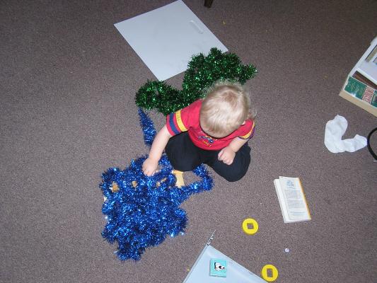 Noah plays with tinsel.