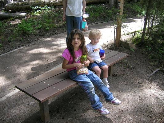Andrea and Noah take a break on a bench.