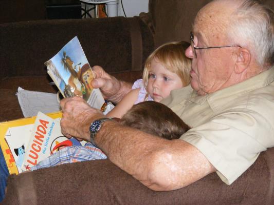 Sarah and Noah read the Tawny Scrawny Lion with Great-Grandpa McElwee