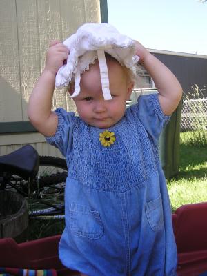 Sarah in the wagon with a hat