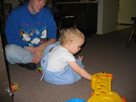 Katie and Noah play with the blocks and the giraffe.