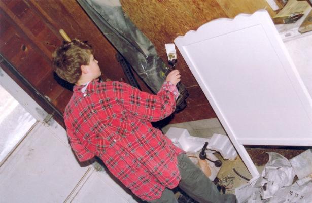 Joe paints Noah's crib