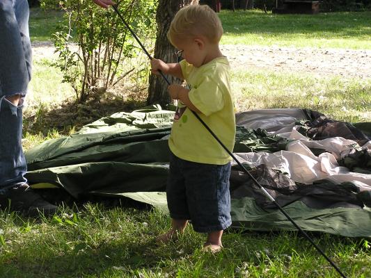 Noah figures out the tent poles.