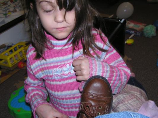 Andrea ties Noah's shoe