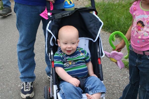 Steven rides in his stroller.
