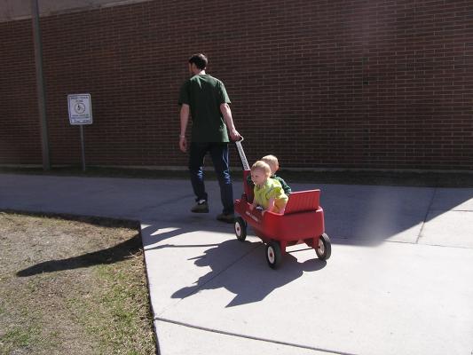 David pulls Noah and Sarah in the wagon.