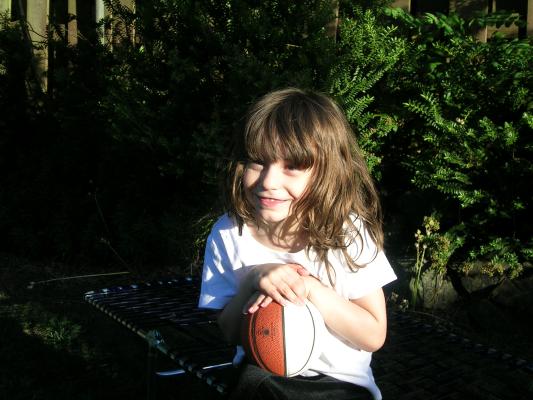 Andrea holds a basketball.