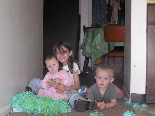 Sarah, Andrea, and Noah with some Easter grass.