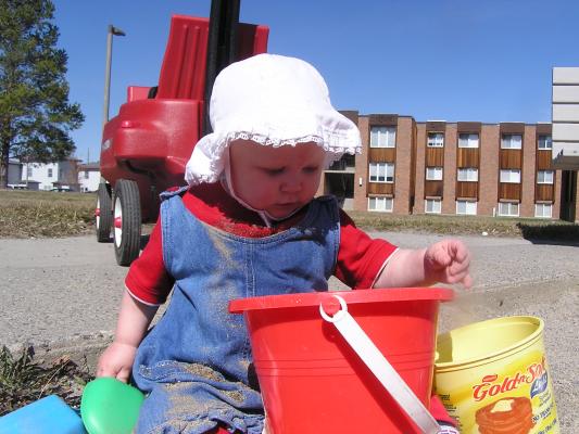 Sarah plays in the sand.
