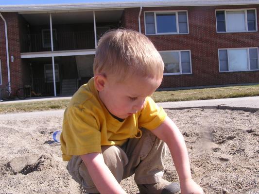 Noah plays in the sand.