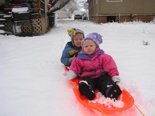 Noah and Sarah ride the sled