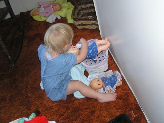 Sarah feeds the doll