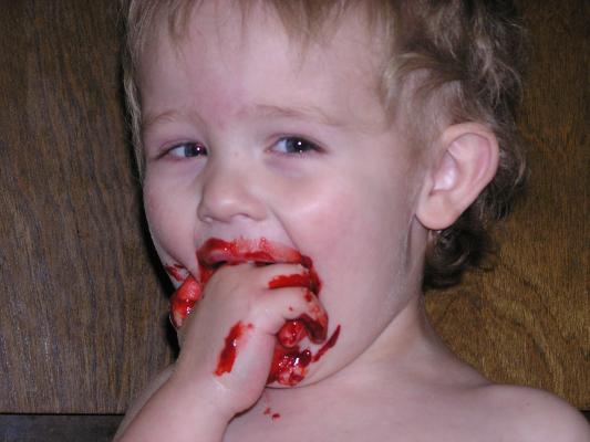 Noah eats some of the red velvet cake batter.