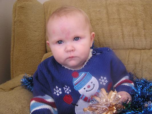 Trying to get a good Christmas photo of Sarah.
She has a new blue sweater.