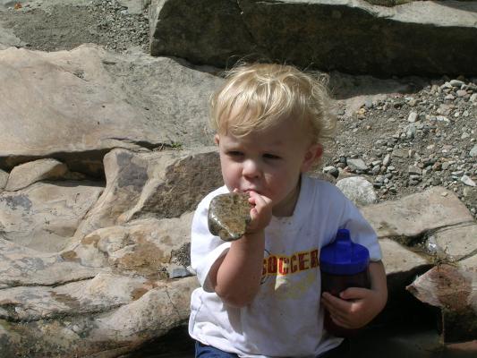 Noah tastes the rocks.