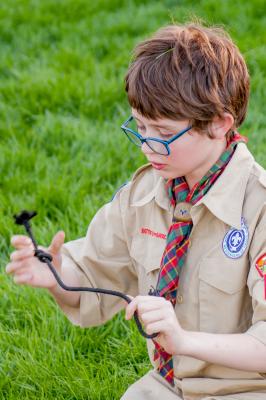 Noah tying knots with the Boy Scouts.