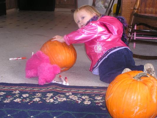 Sarah plays with a pumpkin