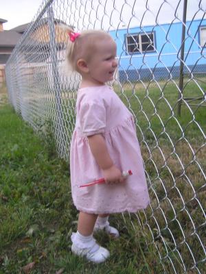 Sarah is in a new pink garage-sale dress with pigtails in her hair.
