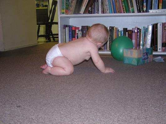 Sarah plays with a green baloon.
