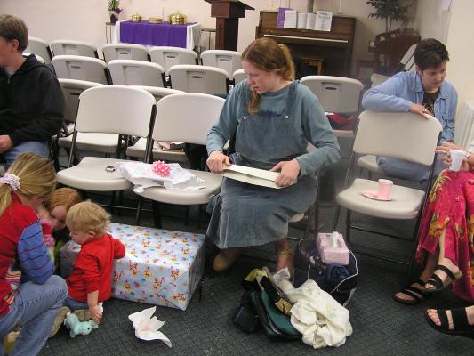 Katie starts opening presents.
