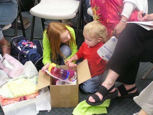The kids look through all the stuff.